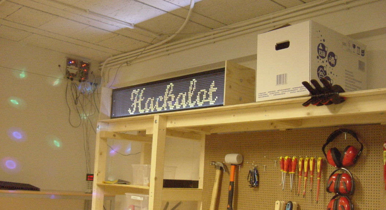 [Flipdot display](https://hackalot.nl/Flipdot) on top of the [tool board](https://hackalot.nl/Gereedschapskast), showing 'Hackalot' logo text.